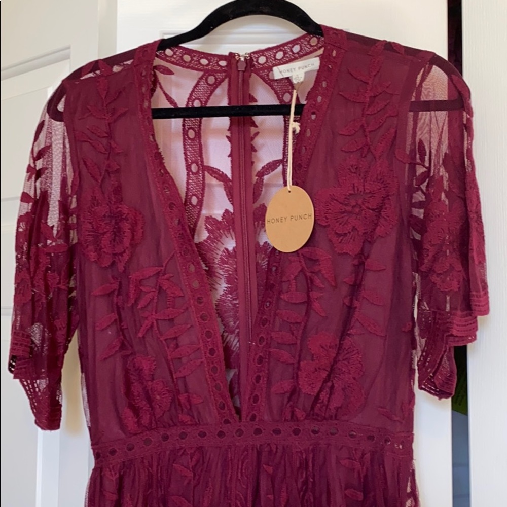 Burgundy v-neck romper with lace overlay.